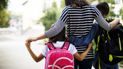 parent walking with 2 children to school